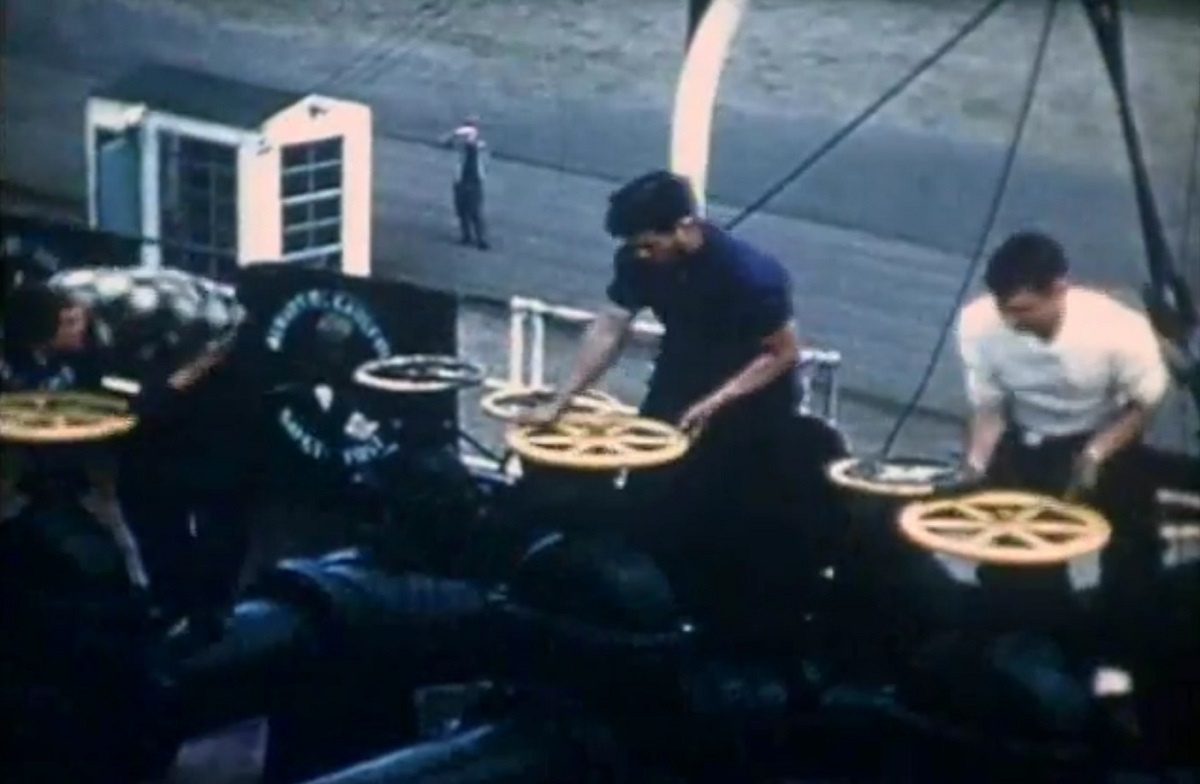 HIstorical image of workers turning block valves